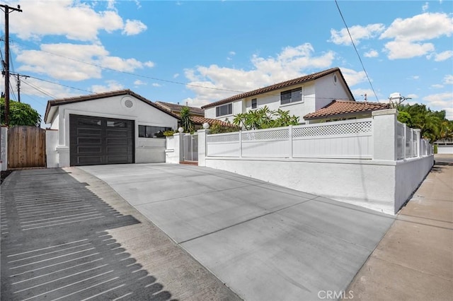 4161 Ricardo Dr, Yorba Linda, CA 92886 - view of front of house featuring stucco siding, a fenced front yard, a gate, and a garage