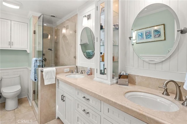 2172 N Pami Cir, Orange, CA 92867 - bathroom featuring double vanity, a shower stall, tile patterned floors, wainscoting, and a decorative wall