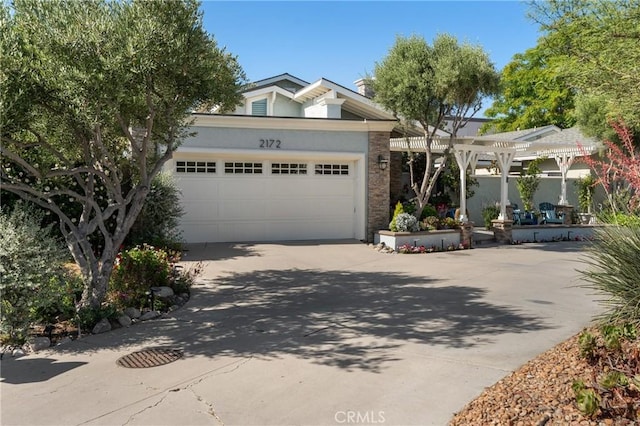 2172 N Pami Cir, Orange, CA 92867 - view of front facade with driveway, an attached garage, stucco siding, and a pergola