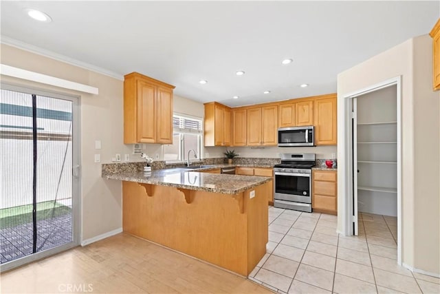 3919 W 242nd St Unit A, Torrance, CA 90505 - kitchen featuring stainless steel appliances, a peninsula, a breakfast bar, light stone countertops, and recessed lighting