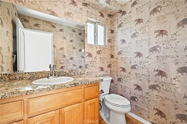 3919 W 242nd St Unit A, Torrance, CA 90505 - half bathroom featuring wallpapered walls, vanity, and wood finished floors