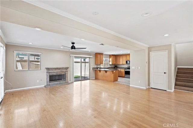 3919 W 242nd St Unit A, Torrance, CA 90505 - unfurnished living room with a ceiling fan, stairs, light wood-style floors, crown molding, and a fireplace