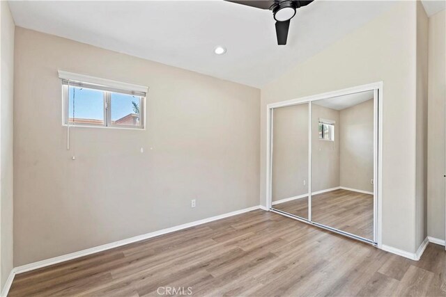 3919 W 242nd St Unit A, Torrance, CA 90505 - unfurnished bedroom featuring light wood-style floors, multiple windows, a closet, lofted ceiling, and ceiling fan