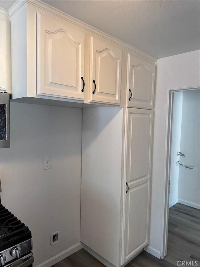 5781 Lime Ave, Cypress, CA 90630 - kitchen with stainless steel gas stove, dark wood-style floors, and white cabinetry