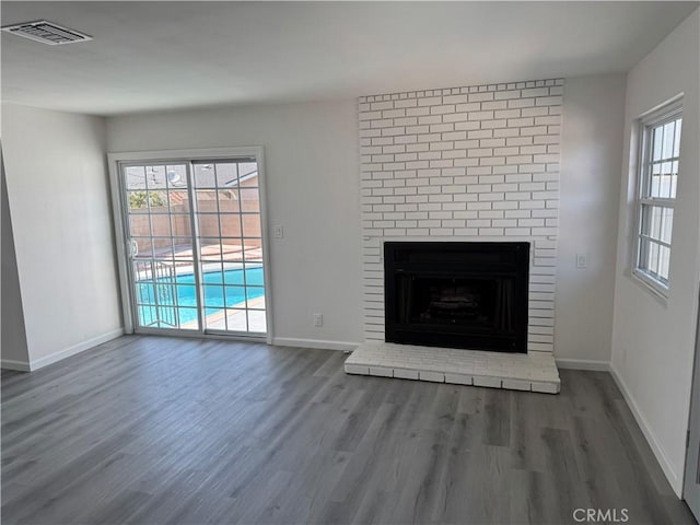 5781 Lime Ave, Cypress, CA 90630 - unfurnished living room with wood finished floors and a brick fireplace