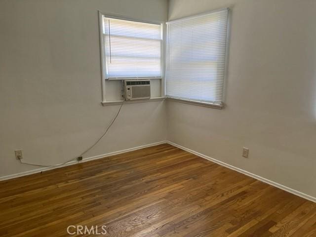 10856 Camarillo St, Toluca Lake, CA 91602 - empty room with wood finished floors and cooling unit