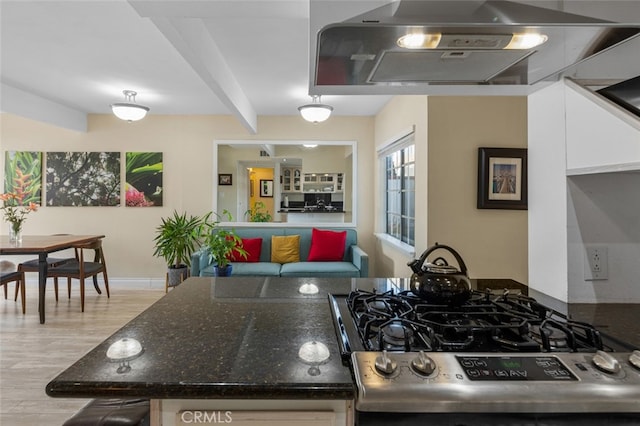 259 62nd, Newport Beach, CA 92663 - kitchen featuring extractor fan, stainless steel range with gas stovetop, light wood-style flooring, white cabinets, and dark stone counters