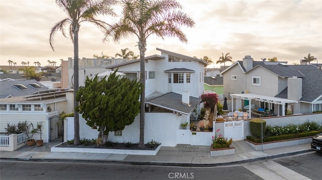 259 62nd, Newport Beach, CA 92663 - view of front of home featuring a residential view, a fenced front yard, a gate, and stucco siding