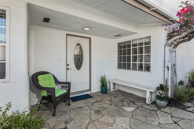 259 62nd, Newport Beach, CA 92663 - doorway to property featuring stucco siding and a porch