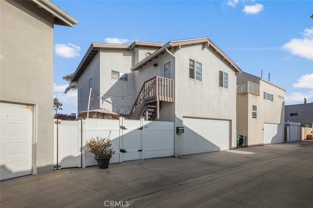 259 62nd, Newport Beach, CA 92663 - back of property featuring a gate, stucco siding, and an attached garage