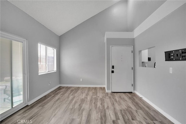 12178 Galaxy St, Victorville, CA 92392 - empty room featuring light wood-style flooring and high vaulted ceiling