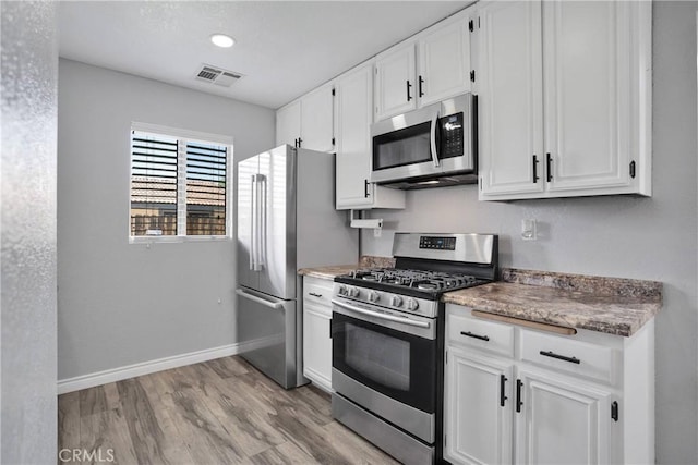 12178 Galaxy St, Victorville, CA 92392 - kitchen featuring appliances with stainless steel finishes, light wood-style flooring, and white cabinets