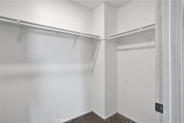 12178 Galaxy St, Victorville, CA 92392 - walk in closet featuring dark colored carpet