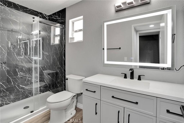 12178 Galaxy St, Victorville, CA 92392 - bathroom featuring vanity, a marble finish shower, and wood finished floors