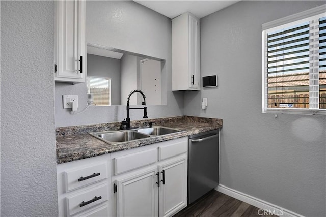 12178 Galaxy St, Victorville, CA 92392 - kitchen with stainless steel dishwasher, dark wood-type flooring, white cabinetry, dark countertops, and a textured wall