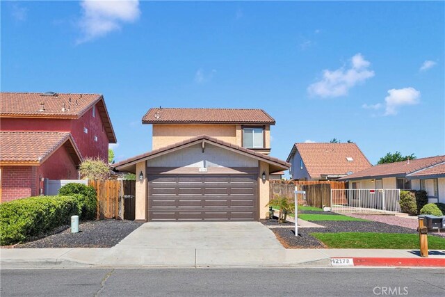 12178 Galaxy St, Victorville, CA 92392 - traditional-style home with driveway, stucco siding, a tiled roof, and an attached garage