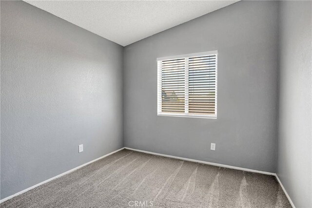 12178 Galaxy St, Victorville, CA 92392 - carpeted spare room with vaulted ceiling and a textured ceiling