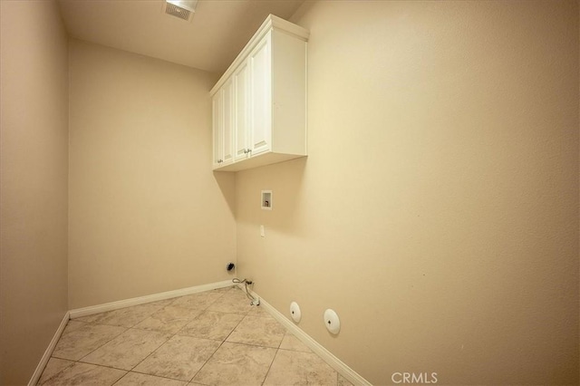 25217 Pacific Crest St, Corona, CA 92883 - laundry area with gas dryer hookup, washer hookup, cabinet space, and light tile patterned floors