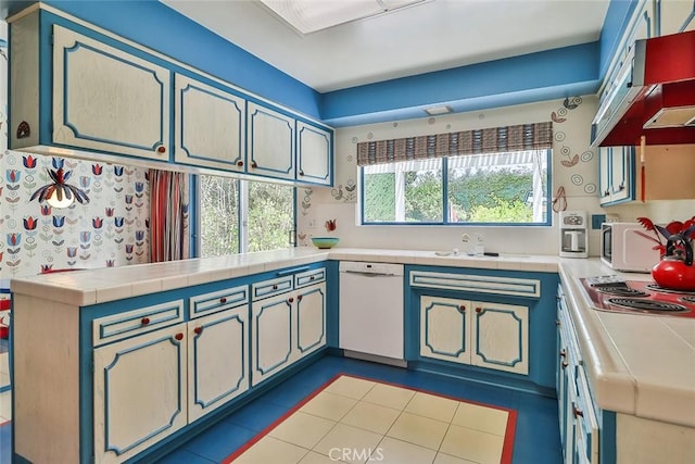 17313 Citronia St, Northridge, CA 91325 - kitchen with dishwasher, tile countertops, a peninsula, and range hood