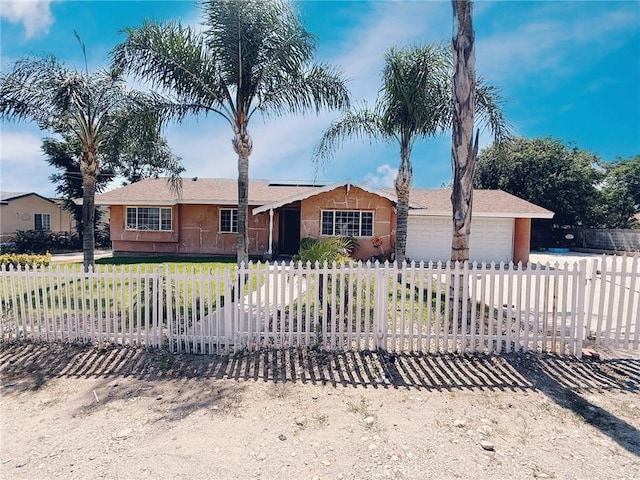 6246 Knox Ave, Fontana, CA 92336 - single story home featuring a fenced front yard, a garage, roof mounted solar panels, and stucco siding