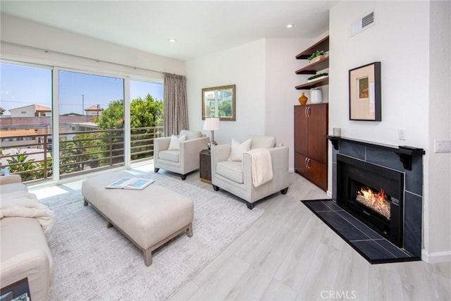 11949 Goshen Ave Unit 308, Los Angeles, CA 90049 - living area featuring a lit fireplace, light wood-style flooring, and recessed lighting