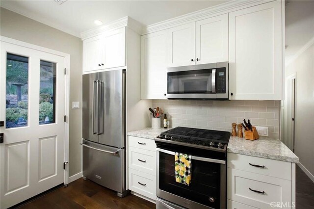6541 Tokay Rd, Tujunga, CA 91042 - kitchen featuring appliances with stainless steel finishes, decorative backsplash, white cabinets, dark wood-style floors, and light stone counters