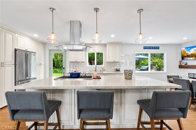 1161 Ravencrest Rd, North Tustin, CA 92705 - kitchen featuring stainless steel appliances, island exhaust hood, recessed lighting, tasteful backsplash, and healthy amount of natural light