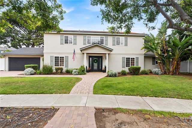 1161 Ravencrest Rd, North Tustin, CA 92705 - view of front of home with stucco siding, an attached garage, a front lawn, and driveway