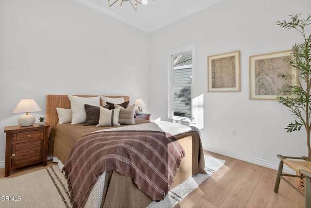 221 N 7th St, Santa Paula, CA 93060 - bedroom with light wood-style flooring, crown molding, and a chandelier
