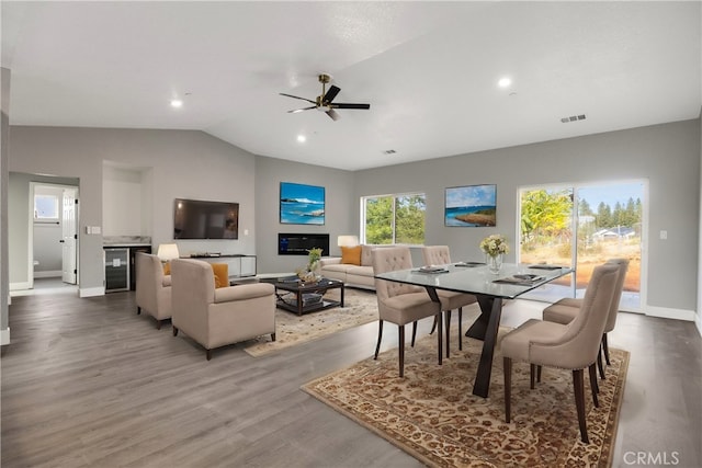 1671 Sweetbriar Ln, Paradise, CA 95969 - dining area with vaulted ceiling, wood finished floors, ceiling fan, recessed lighting, and wine cooler