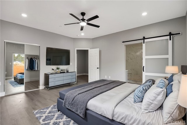1671 Sweetbriar Ln, Paradise, CA 95969 - bedroom featuring a barn door, wood finished floors, a closet, recessed lighting, and ensuite bath