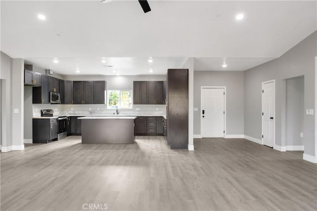 1671 Sweetbriar Ln, Paradise, CA 95969 - kitchen featuring appliances with stainless steel finishes, open floor plan, light wood finished floors, light countertops, and recessed lighting