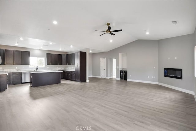 1671 Sweetbriar Ln, Paradise, CA 95969 - unfurnished living room featuring ceiling fan, recessed lighting, light wood-type flooring, a glass covered fireplace, and vaulted ceiling