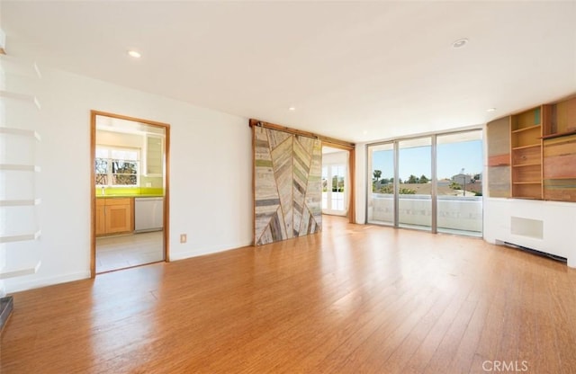 750 S Windsor Blvd Unit 7, Los Angeles, CA 90005 - unfurnished living room with light wood-style floors, floor to ceiling windows, and recessed lighting