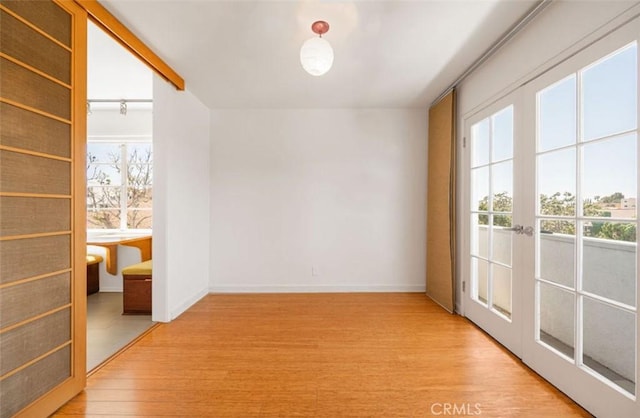 750 S Windsor Blvd Unit 7, Los Angeles, CA 90005 - empty room with light wood-style flooring and french doors