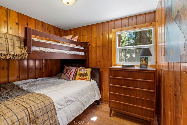 27917 Squirrel Ln, Lake Arrowhead, CA 92352 - bedroom featuring wood walls and wood finished floors