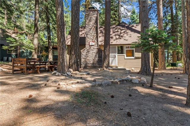 27917 Squirrel Ln, Lake Arrowhead, CA 92352 - back of house with a chimney
