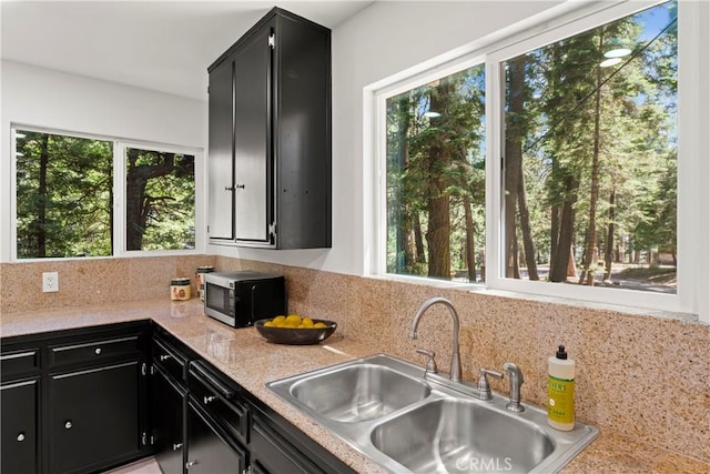 27917 Squirrel Ln, Lake Arrowhead, CA 92352 - kitchen featuring dark cabinetry, stainless steel microwave, and plenty of natural light