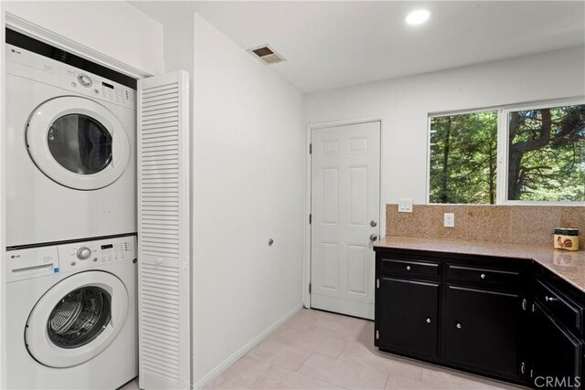 27917 Squirrel Ln, Lake Arrowhead, CA 92352 - laundry room with stacked washer / drying machine and light tile patterned floors