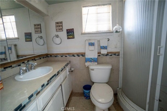22731 Bryman Rd, Oro Grande, CA 92368 - full bathroom with vanity, tile walls, a shower stall, and wainscoting