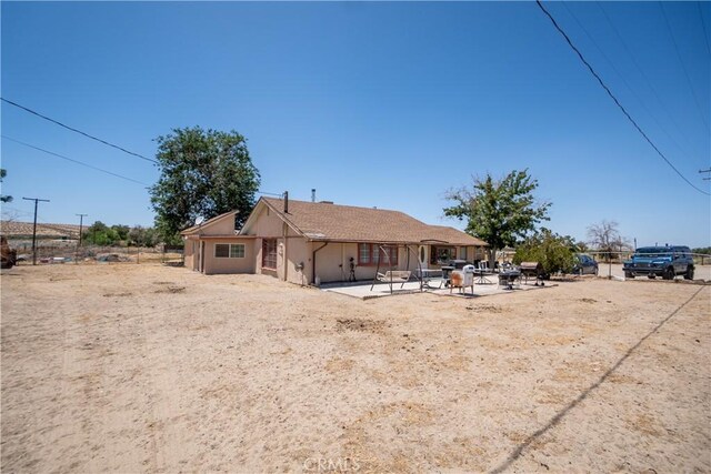 22731 Bryman Rd, Oro Grande, CA 92368 - rear view of property featuring a patio and stucco siding