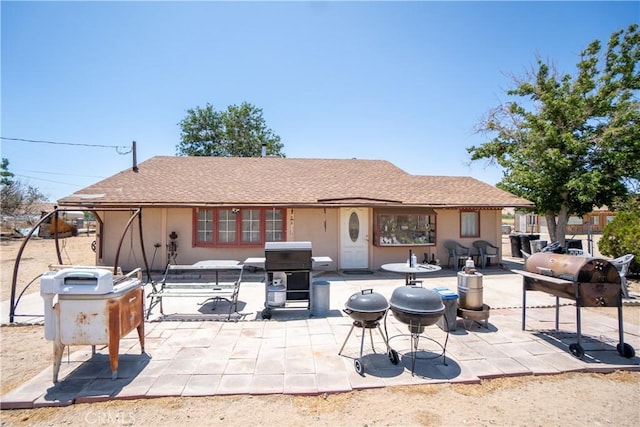 22731 Bryman Rd, Oro Grande, CA 92368 - rear view of property featuring a patio area, stucco siding, and a shingled roof