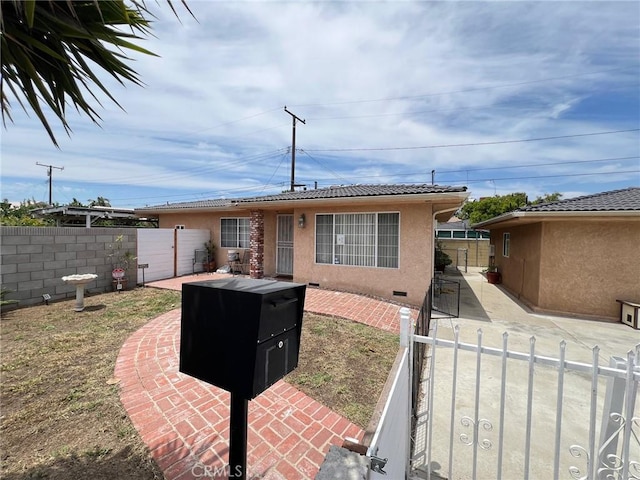 22605 Kinard Ave, Carson, CA 90745 - rear view of house with a patio area, stucco siding, a tiled roof, and a gate