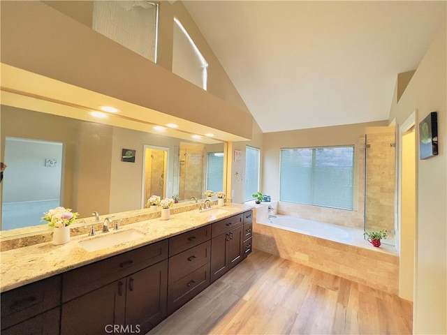 17346 Cold Spring Cir, Riverside, CA 92503 - full bath featuring a bath, double vanity, wood finished floors, high vaulted ceiling, and tiled shower
