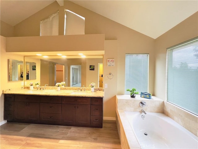 17346 Cold Spring Cir, Riverside, CA 92503 - bathroom with a garden tub, double vanity, wood finished floors, and high vaulted ceiling