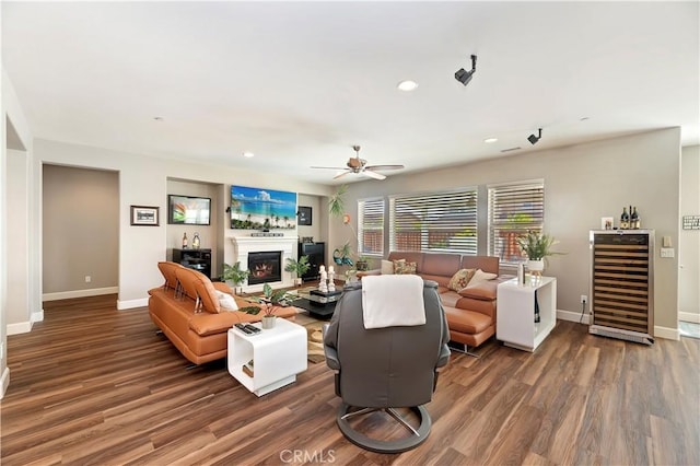 27843 Huron Ct, Menifee, CA 92585 - living room with beverage cooler, wood finished floors, recessed lighting, a warm lit fireplace, and a ceiling fan