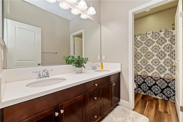 27843 Huron Ct, Menifee, CA 92585 - full bathroom with double vanity, wood finished floors, and curtained shower