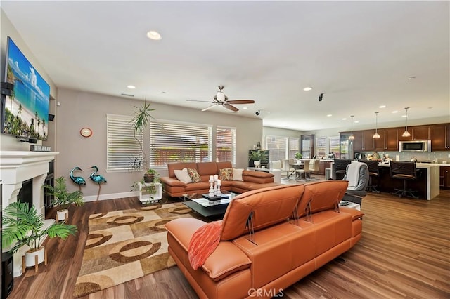 27843 Huron Ct, Menifee, CA 92585 - living area featuring a fireplace, wood finished floors, recessed lighting, and ceiling fan