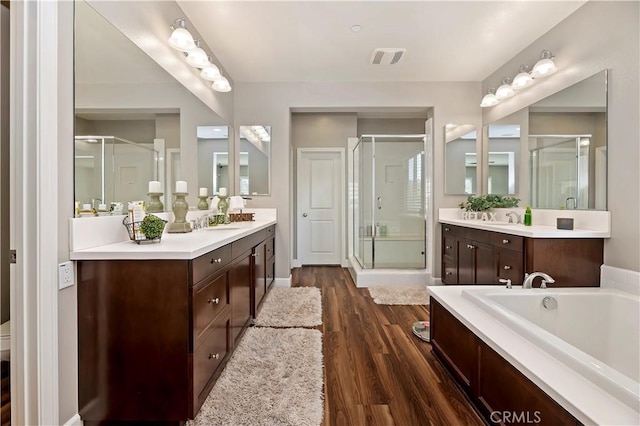 27843 Huron Ct, Menifee, CA 92585 - bathroom featuring a stall shower, vanity, wood finished floors, and a garden tub