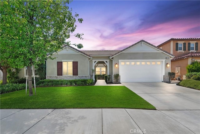 27843 Huron Ct, Menifee, CA 92585 - view of front facade with stucco siding, concrete driveway, an attached garage, a lawn, and a tiled roof